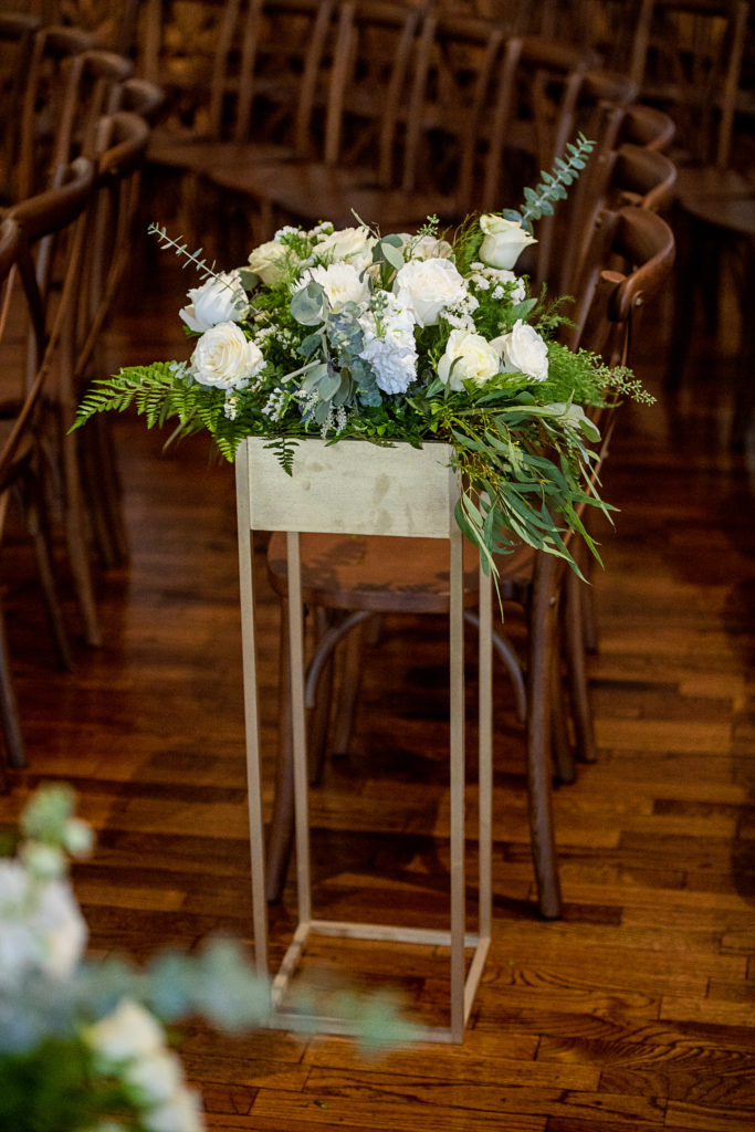 Gorgeous white roses and eucalyptus in tall gold box for wedding florals