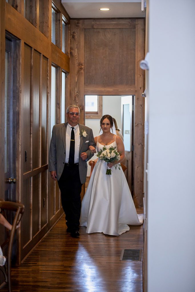 Bride and father walk down the aisle at the Territory Ballroom
