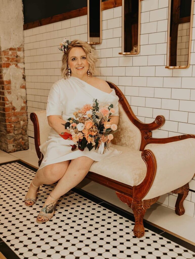 dried bridal bouquet held by vintage bride